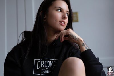Tattooed Brunette Octavia May In Black Hoodie Teasing By The Window - photo 02