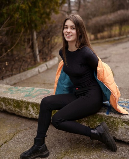 Danna Bliss Outdoor Tease In Black Outfit And Orange Jacket Scene