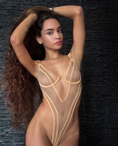 Dulce In Sheer Lingerie Strips Nude By Black Stone Wall