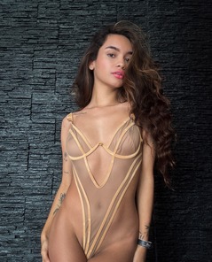 Dulce In Sheer Lingerie Strips Nude By Black Stone Wall